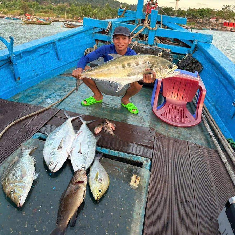 Local crew member on deck with the day catch off Da Nang
